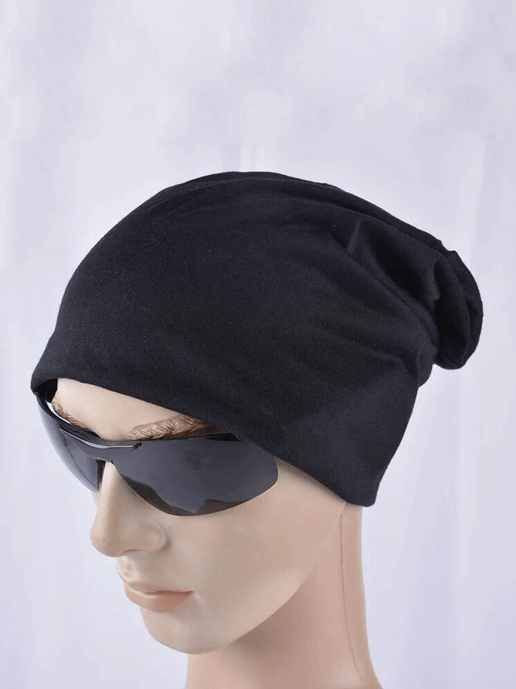 Solid Color Casual Sports Men's Beanie SF1696 in black polyester, modeled with sunglasses, showcasing its snug fit and stylish look.